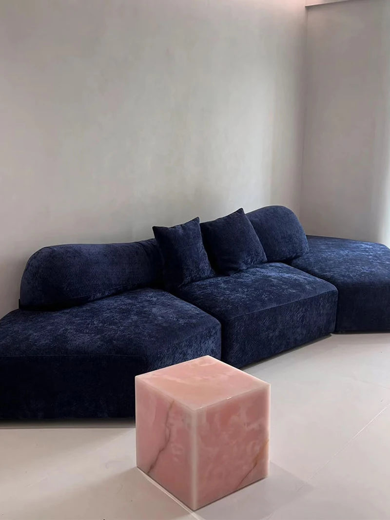 Pink Jade Side Table paired with Navy Blue Sculptural Sofa | LuxuryMarbleHome